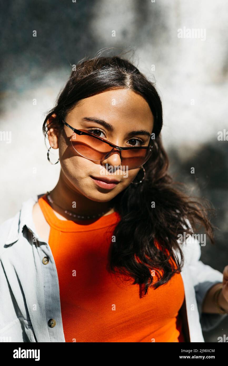 Portrait of a young woman with orange glasses Stock Photo
