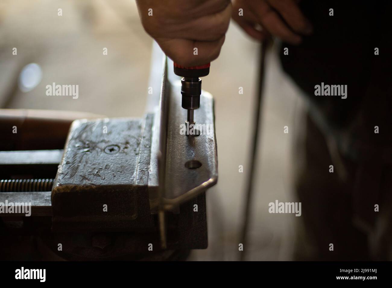 Grinding holes in steel. Removal of excess metal. Create steel part. Hand tools. Hand holds