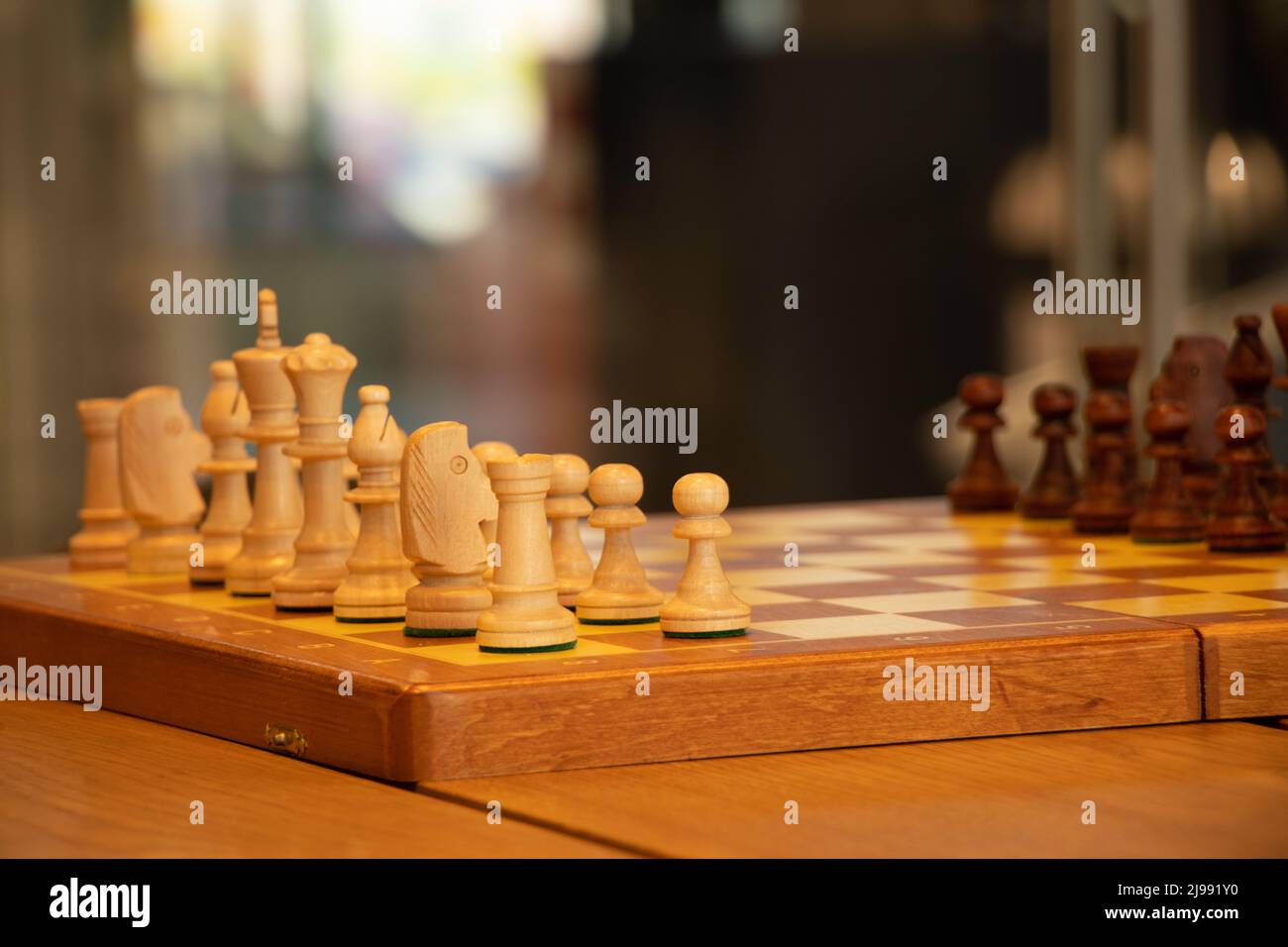 brown chess board with figures on a wooden table in a cafe, playing chess  Stock Photo - Alamy