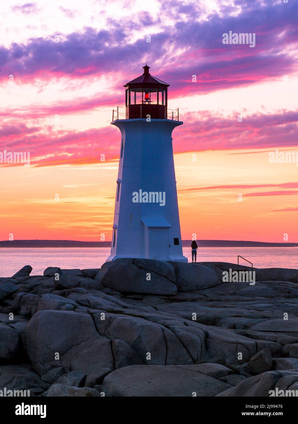 Peggy's Cove Lighthouse during a vibrant sunset. Atlantic Coast, Nova