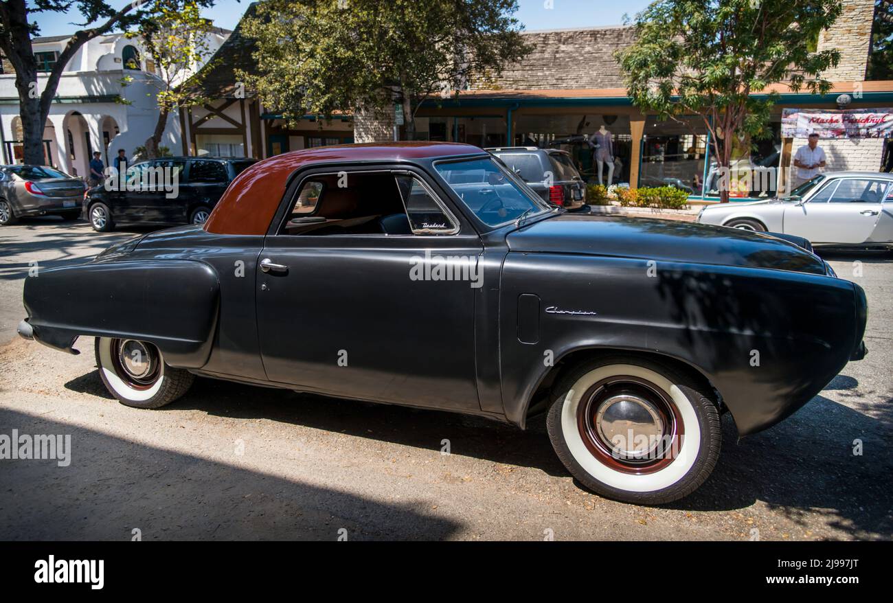 A Studebaker parked at the Pebble Beach Tour d'Elegance as it passed through Carmel-by-the-Sea, California during Monterey Car Week Stock Photo