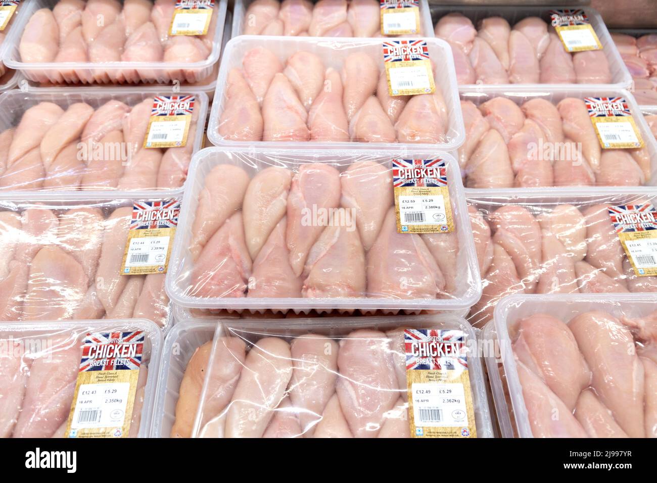Packaged raw chicken breasts in a supermarket fridge Stock Photo