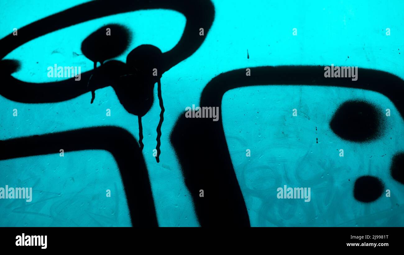 Vandalism with black paint. Paint spray on plastic. Soiled surface. Graffiti details Stock Photo