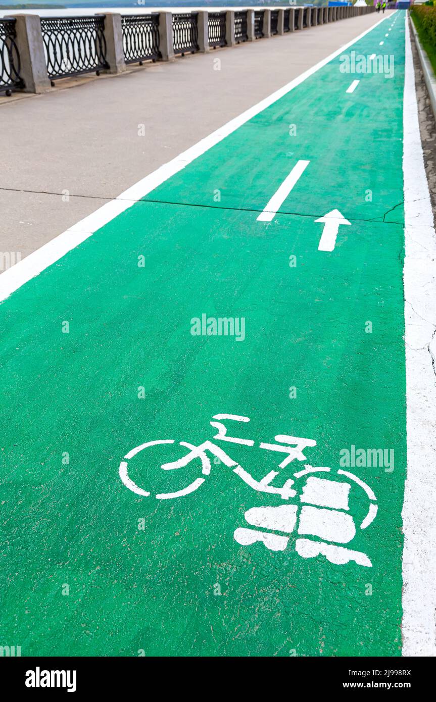 Dedicated bicycle lane with bicycle and roller skates sign, designed to make cycling safer on the asphalt road Stock Photo