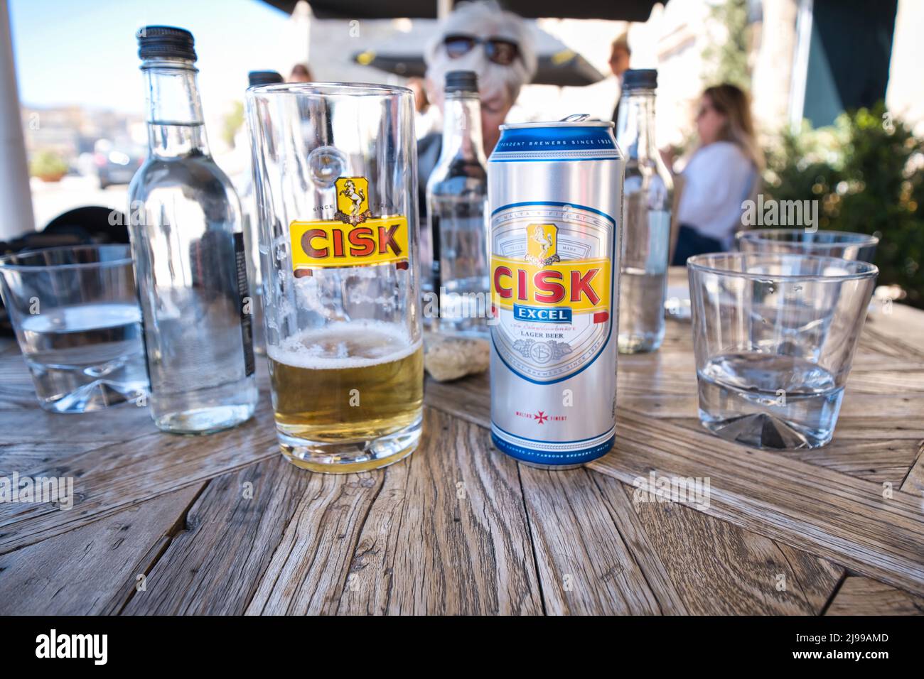 Close up of a table and a can and a glass of Cisk beer, a maltese product, in La Valletta Stock Photo