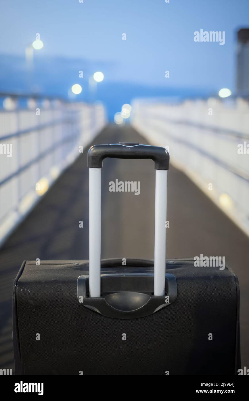 Black suitcase or luggage on the footbridge at the railway station Stock Photo