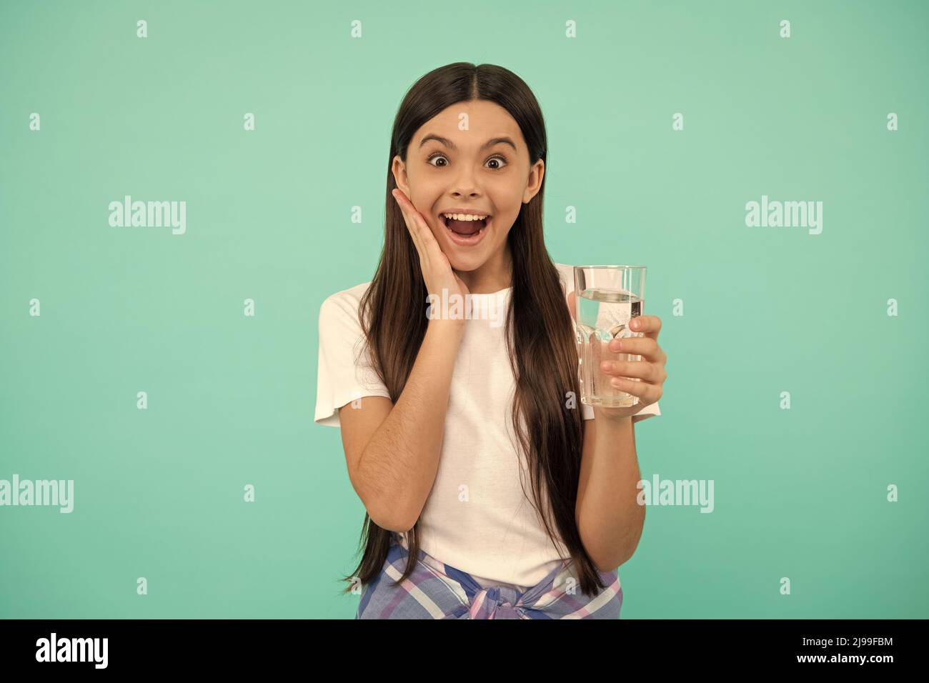 surprised child drink water to stay hydrated and keep daily water