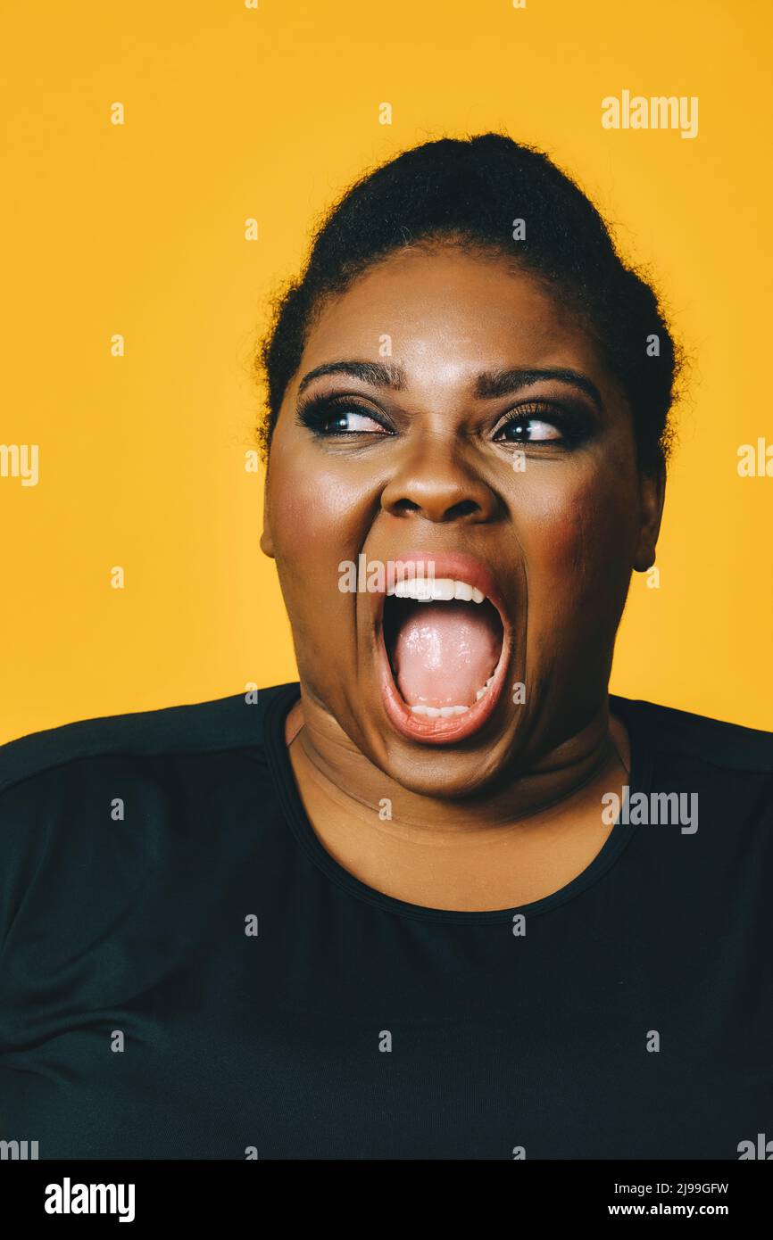A beautiful young woman in a portrait image laughing with her mouth open  and big breasts in a black, Stock Photo, Picture And Low Budget Royalty  Free Image. Pic. ESY-054166238