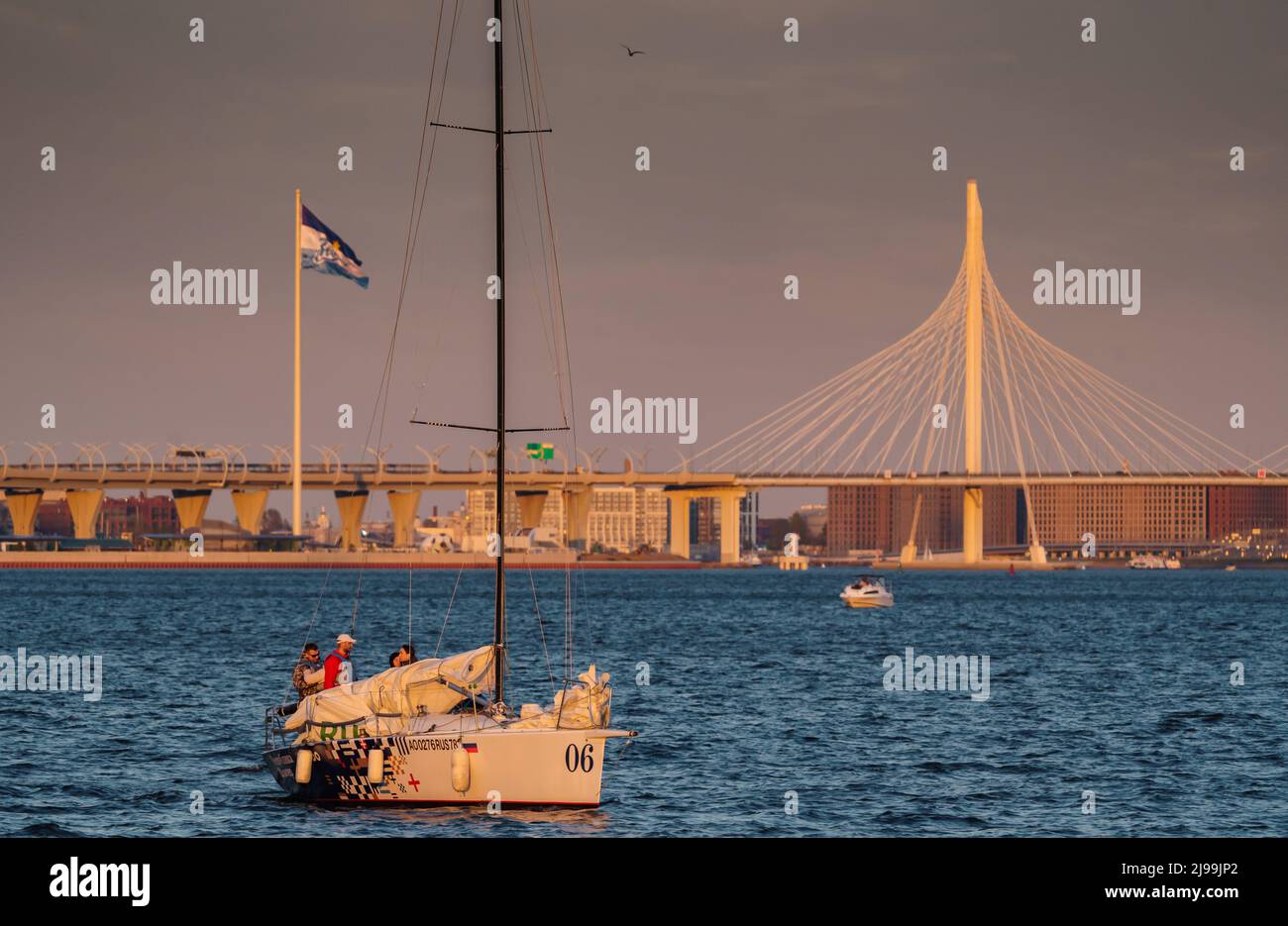 Russia, St. Petersburg, 20 May 2022: Sailing boats in the background of the new cable stayed bridge in sunset light Stock Photo