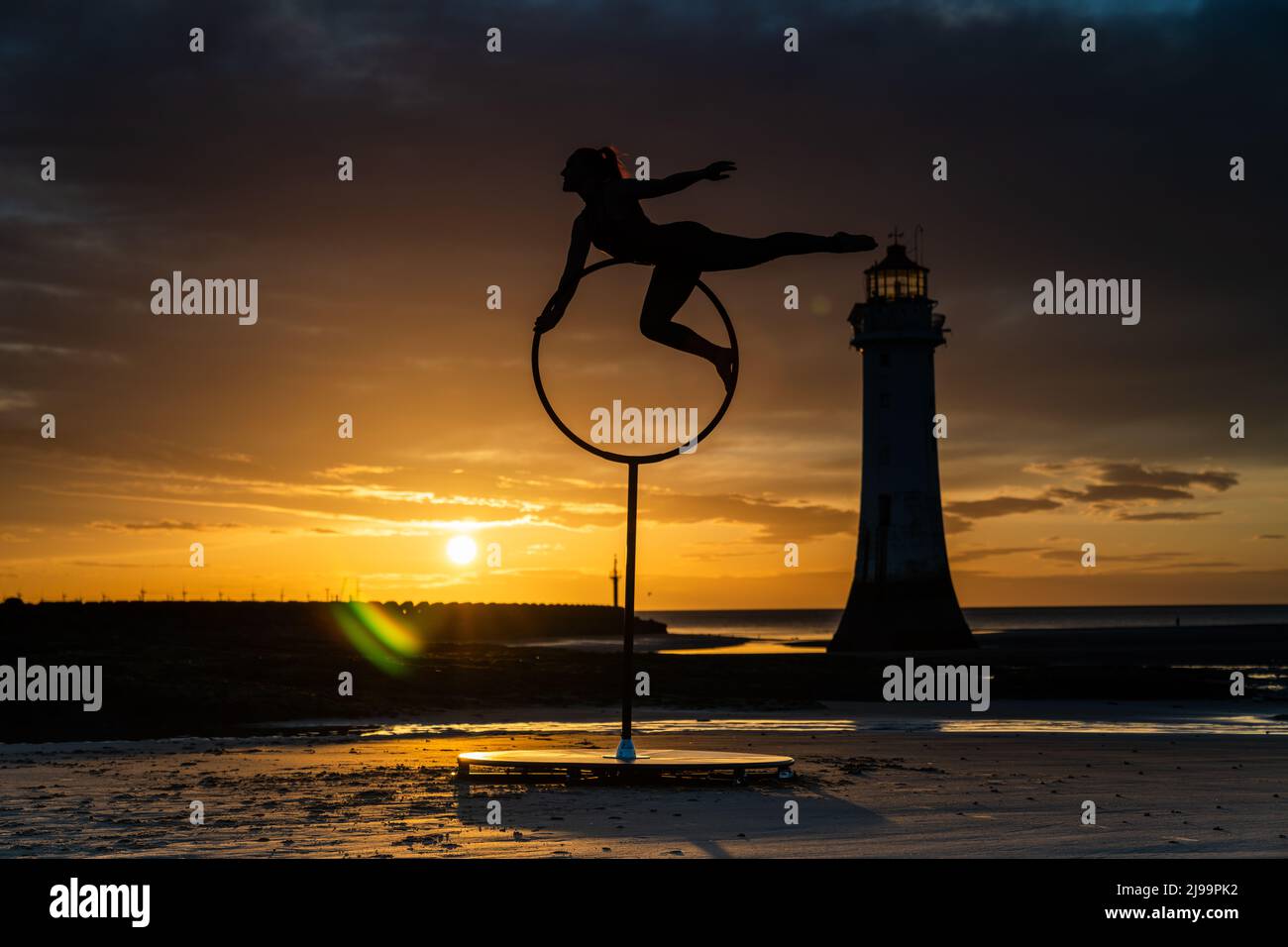 New Brighton, UK. 22nd May 2022 - Aerial artist, Megan Price practicing on New Brighton beach on the Wirral at sunset. Credit: Christopher Middleton/Alamy Live News Stock Photo