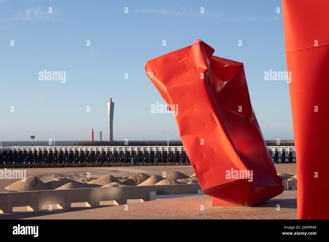 Red 'Rock Strangers' Sculpture at the harbour's mouth in Ostend Belgium Stock Photo