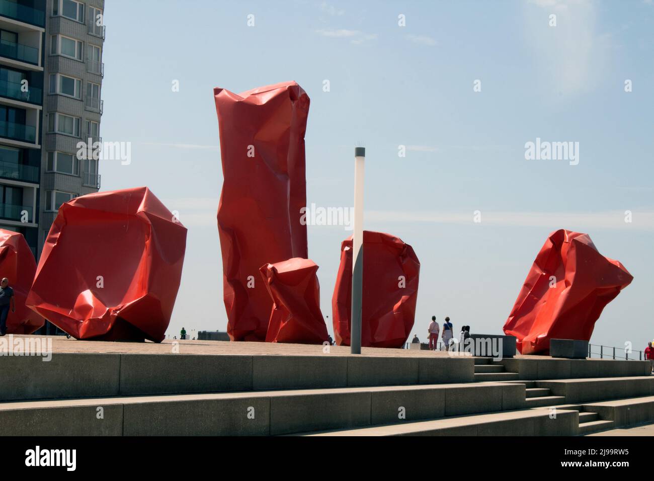 Red 'Rock Strangers' Sculpture at the harbour's mouth in Ostend Belgium Stock Photo