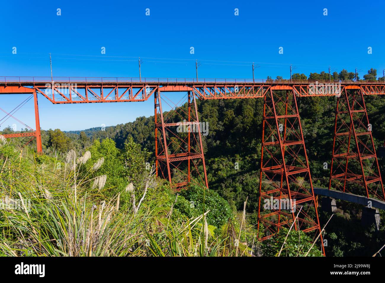 Red structure of Makatote Viaduct, Bridge number 179, against New