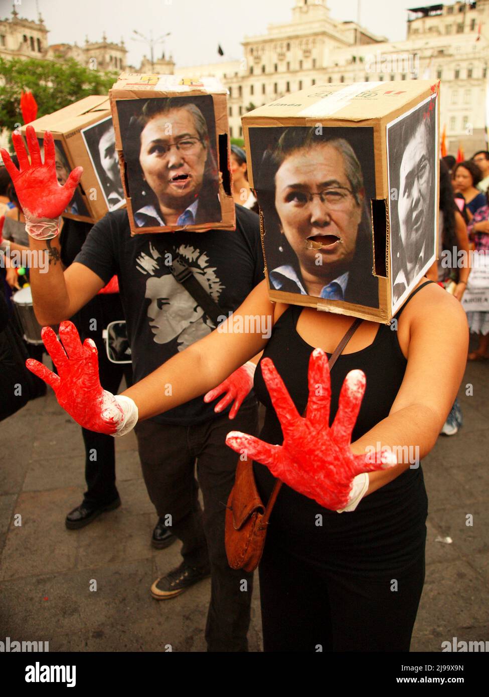 Hundreds of activists, costumed as Alberto Fujimori showing their bloody hands, took by force the main square of Lima, in the aniversary of the coup d'etat of Alberto Fujimori. The demonstrators demanded for non oblivion and no impunity for the responsibles thousands of disappeared, forced sterilizations, corruption, and trimming of civil liberties during the Fujimori government. Stock Photo