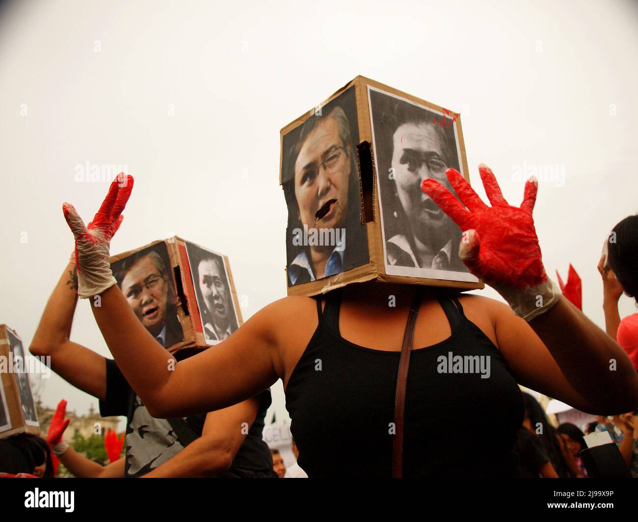 Hundreds of activists, costumed as Alberto Fujimori showing their bloody hands, took by force the main square of Lima, in the aniversary of the coup d'etat of Alberto Fujimori. The demonstrators demanded for non oblivion and no impunity for the responsibles thousands of disappeared, forced sterilizations, corruption, and trimming of civil liberties during the Fujimori government. Stock Photo