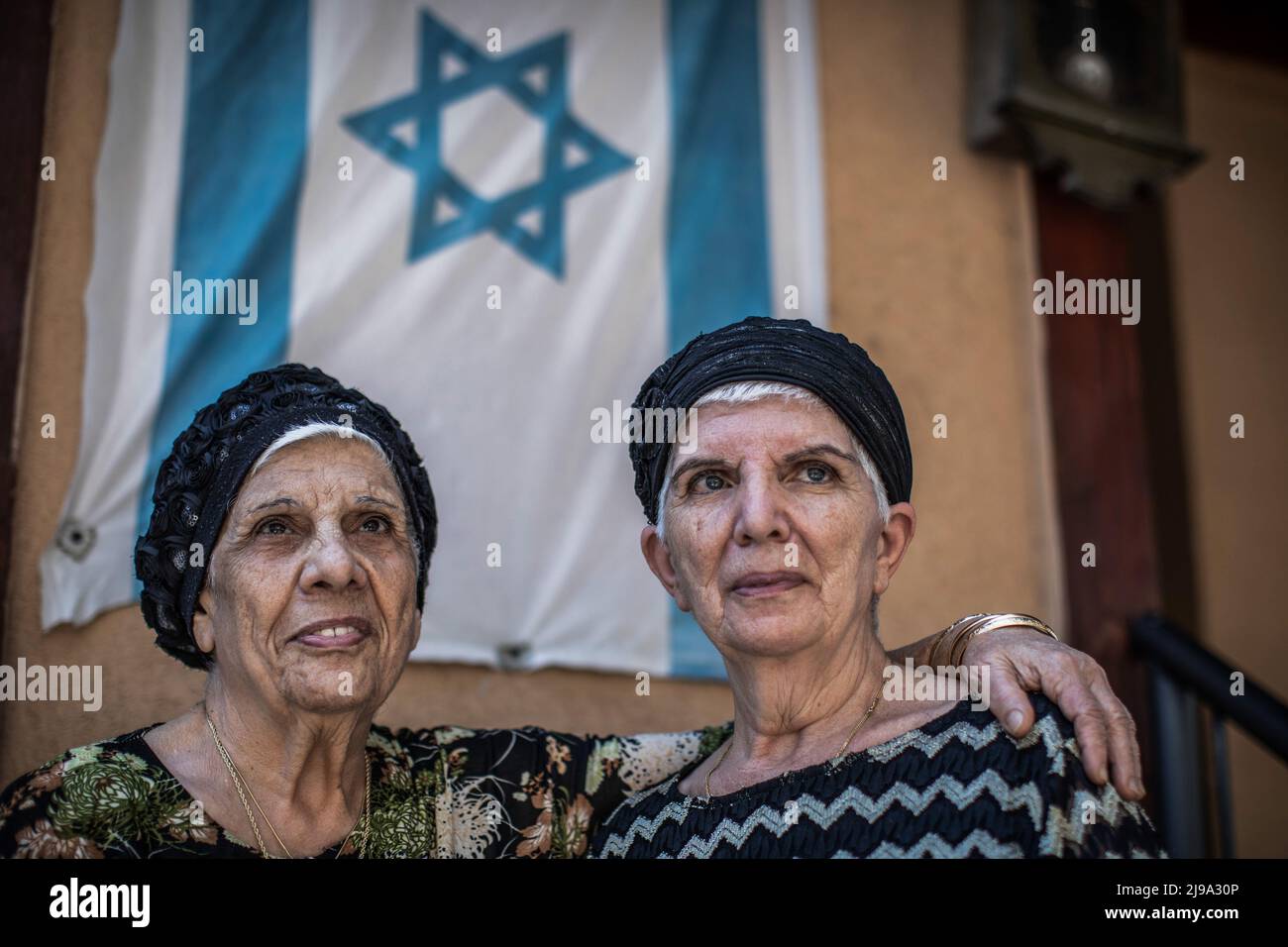18 May 2022, Israel, Kiryat Bialik: Masal Berko (r) and Chaja Masus stand in front of their house. The parents of the two had come to Haifa from the Tunisian island of Djerba with their eight children in 1948. The affair of disappeared children of Jews from Yemen and other Oriental countries is one of the most painful in Israeli history. In the search for the truth, the grave of her brother Usiel, born in 1952 and died in 1953, is now to be opened on Monday. The boy had contracted polio at the age of 10 months. For the follow-up treatment, the parents, who at that time already had three other  Stock Photo