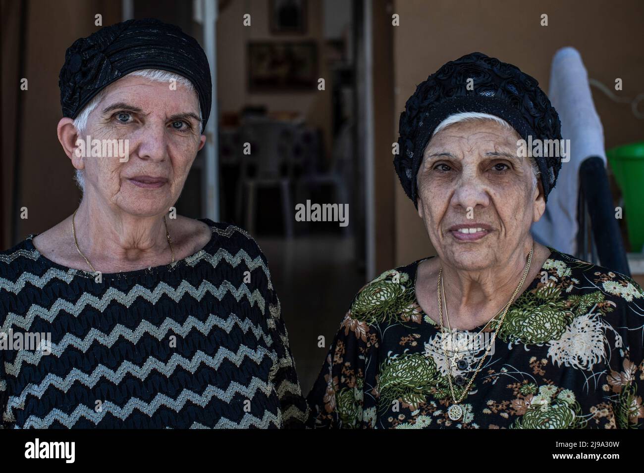 18 May 2022, Israel, Kiryat Bialik: Masal Berko (l) and Chaja Masus stand in front of their house. The parents of the two had come to Haifa with their eight children from the Tunisian island of Djerba in 1948. The affair of disappeared children of Jews from Yemen and other Oriental countries is one of the most painful in Israeli history. In the search for the truth, the grave of her brother Usiel, born in 1952 and died in 1953, is now to be opened on Monday. The boy had contracted polio at the age of 10 months. For the follow-up treatment, the parents, who at that time already had three other  Stock Photo