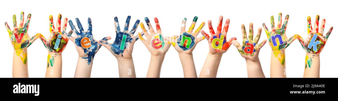 Child's hands in paint making phrase VIELEN DANK (German for Thanks a lot) on white background Stock Photo