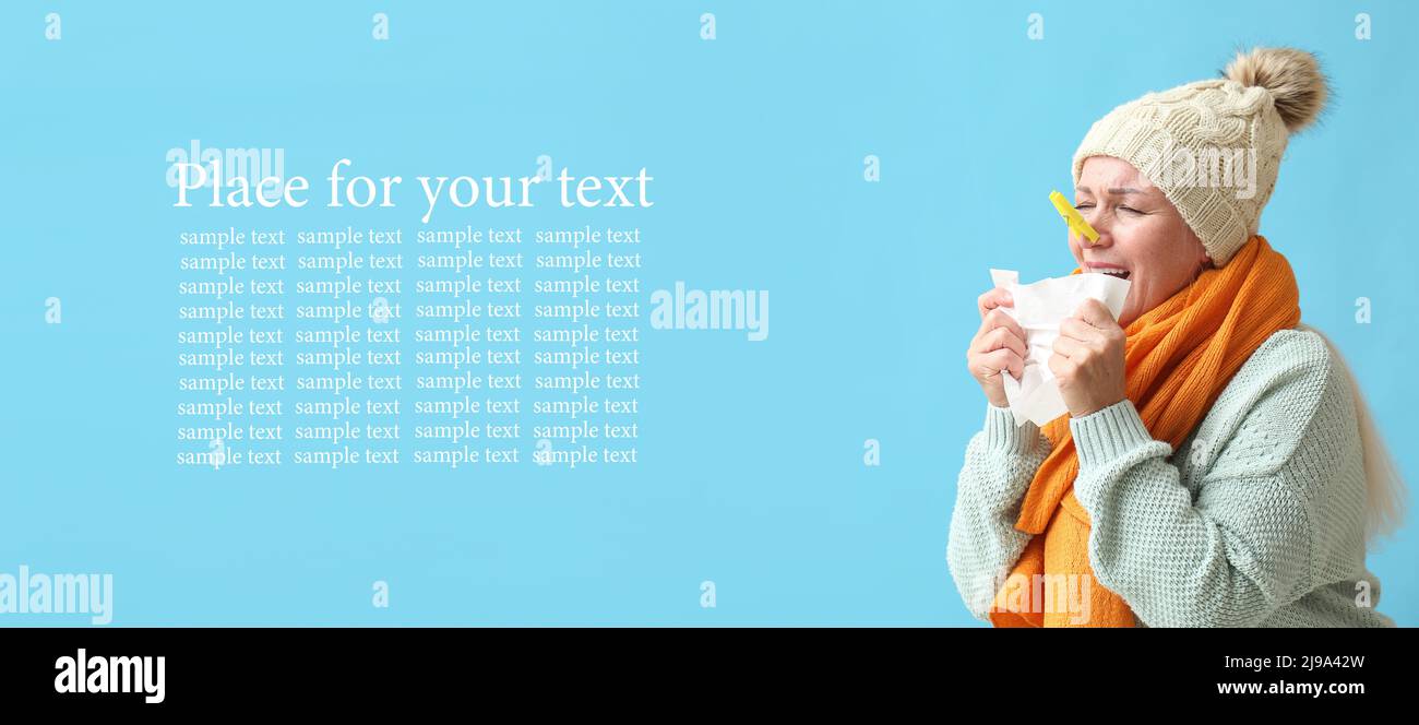Ill mature woman with clothespin on her nose against light blue background with space for text