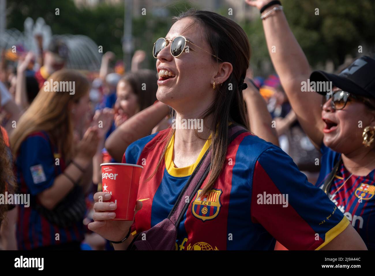 Barcelona, Spain. 21st May, 2022. A female Barcelona Football Club supporter wearing the club's shirt is seen chanting slogans before the start of the match. Followers of the Barcelona Women's Soccer Club gathered at Plaza Catalunya to follow on a giant screen the final of the women's Champions League between Olympique of Lyon Women and FC Barcelona Women. Final score Olympique of Lyon Women 3-1 FC Barcelona Women. (Photo by Paco Freire/SOPA Images/Sipa USA) Credit: Sipa USA/Alamy Live News Stock Photo