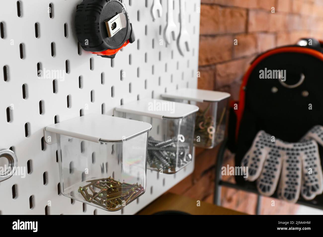 Pegboard with different tools on brick wall, closeup Stock Photo Alamy