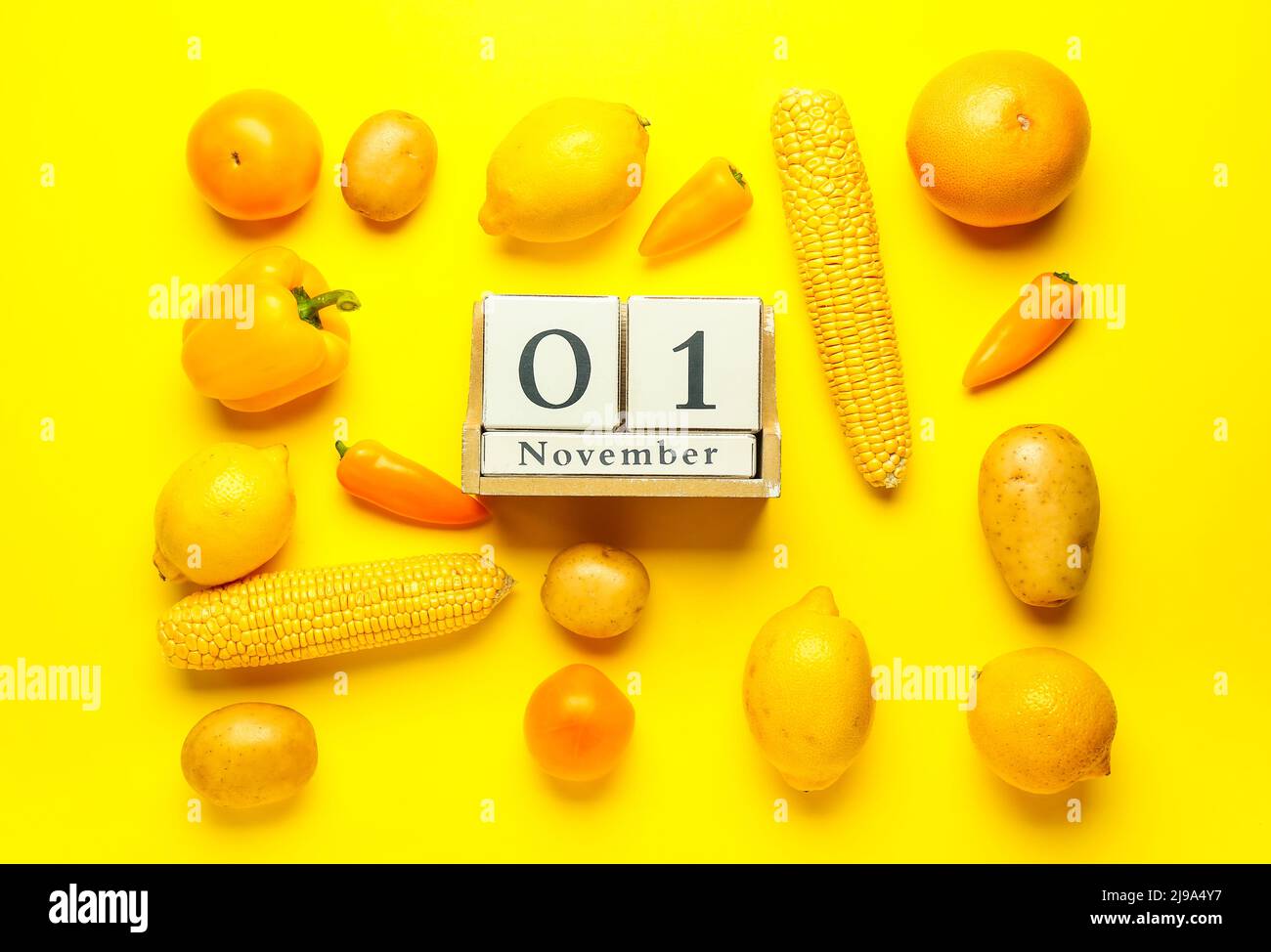 Wooden cube calendar with date NOVEMBER 1, fresh vegetables and fruits