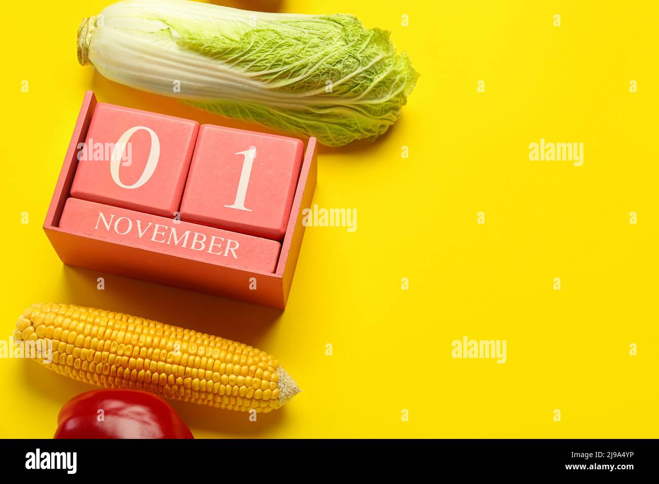 Vegetables and cube calendar with date NOVEMBER 1 on yellow background