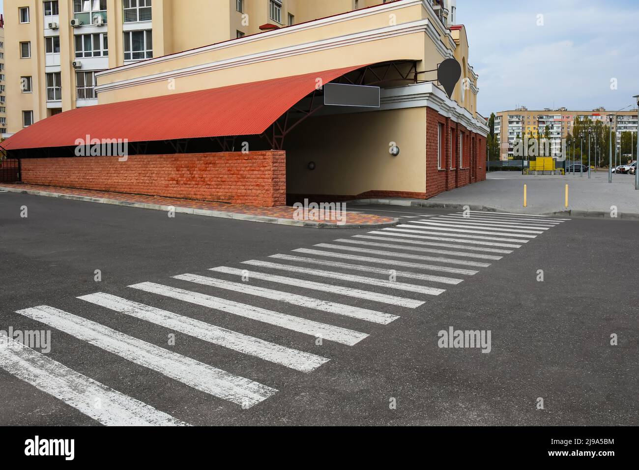 Pedestrian crossing on road near parking in city Stock Photo - Alamy
