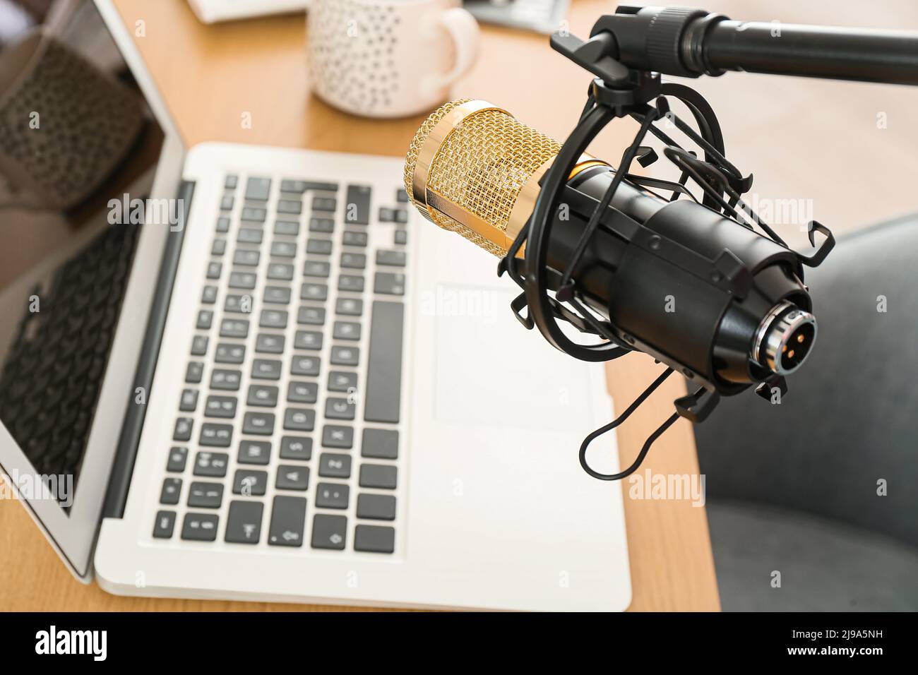 Professional microphone near modern workplace, closeup Stock Photo Alamy