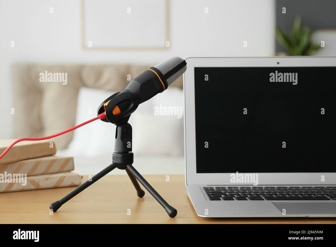 Modern microphone and laptop on table in studio Stock Photo Alamy