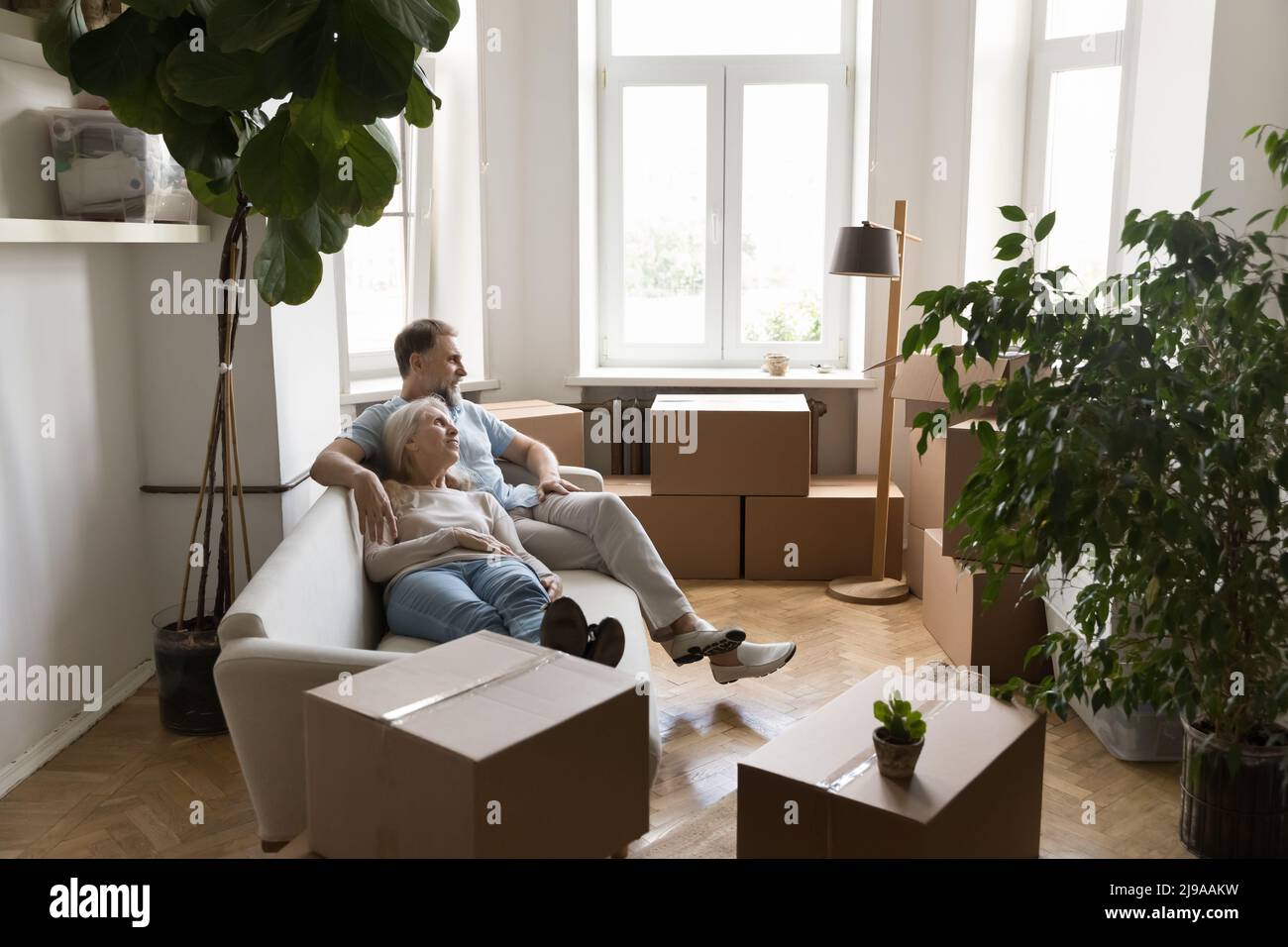 Happy retired couple taking break from moving into new flat Stock Photo