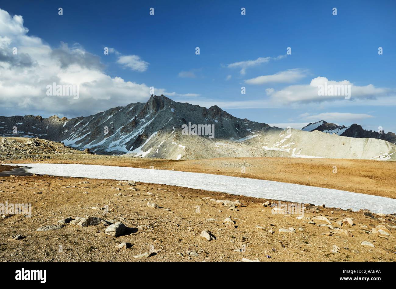 Beautiful scenery of the big ice glacier and snow mountains at cloudy blue in Tien Shan, Kazakhstan. Stock Photo