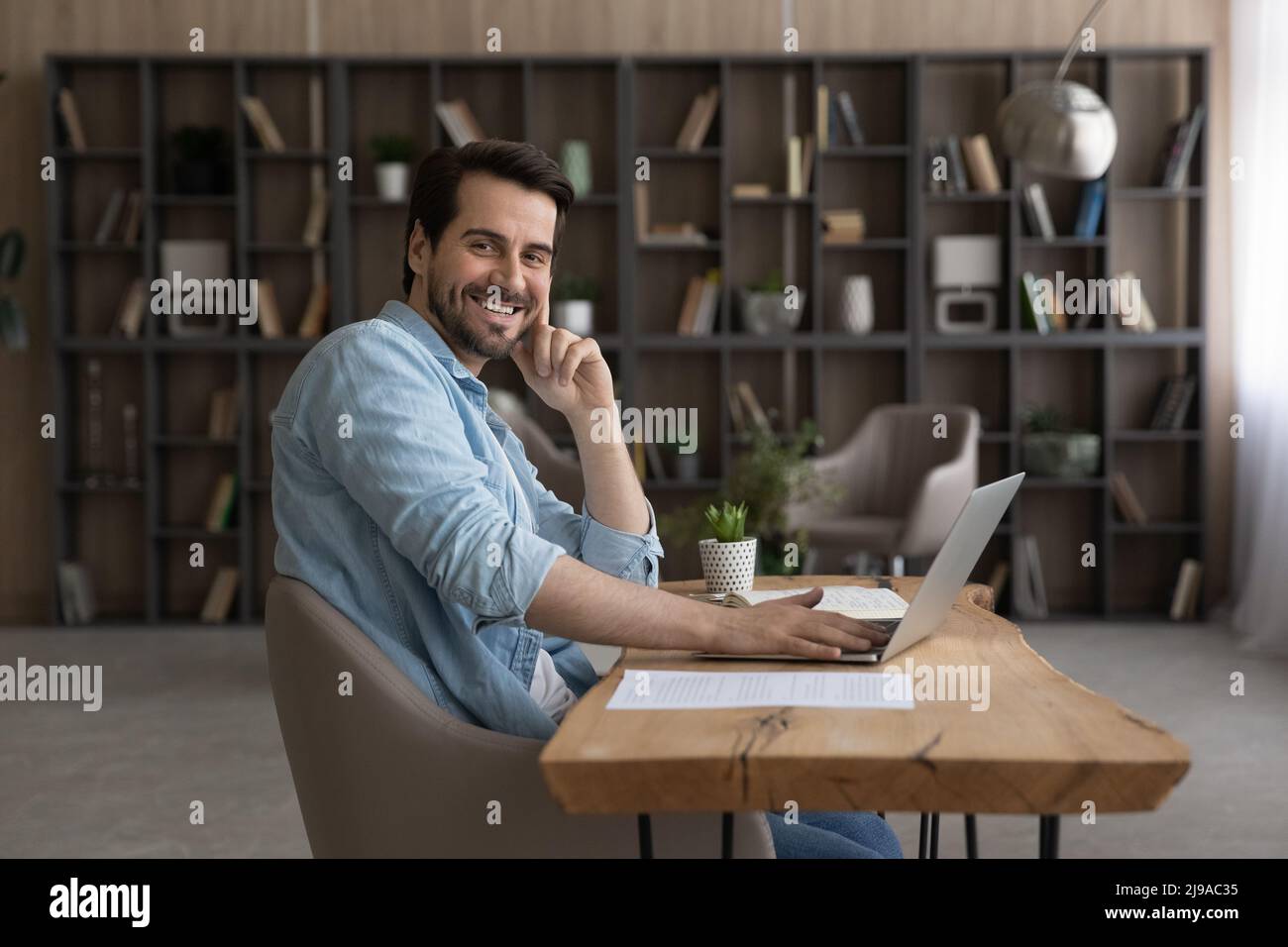 Portrait of young man work at home office by pc Stock Photo