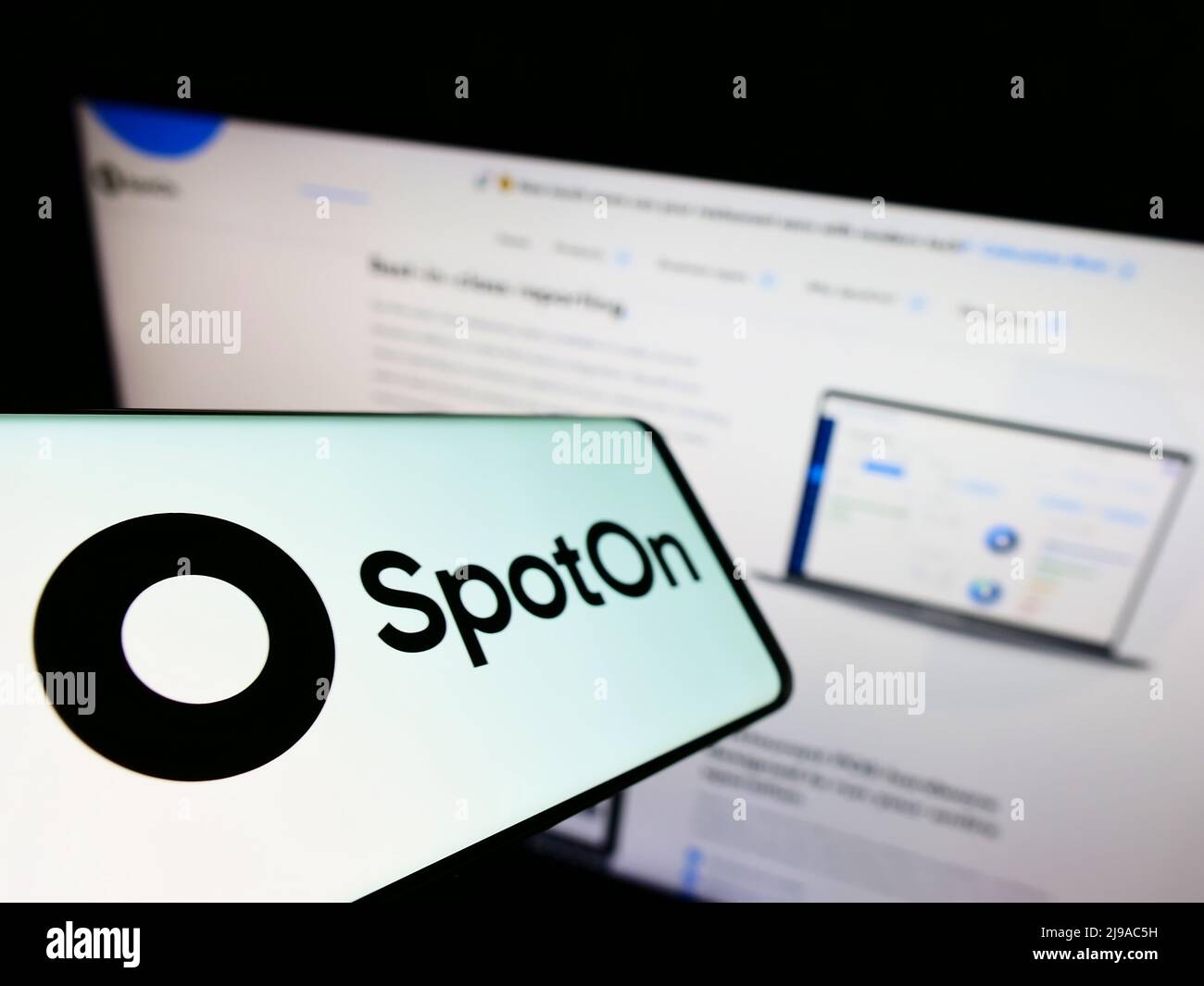 Smartphone with logo of American software company SpotOn Transact LLC on screen in front of website. Focus on center-left of phone display. Stock Photo