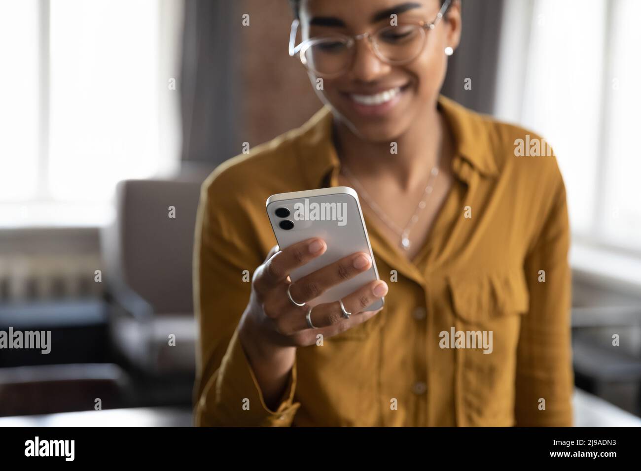 Close up cropped view African woman using smartphone Stock Photo