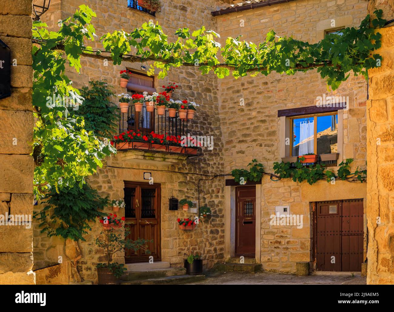 Old stone houses and narrow cobblestone streets in a picturesque medieval village of Ujue in the Basque Country, Navarra, Spain Stock Photo