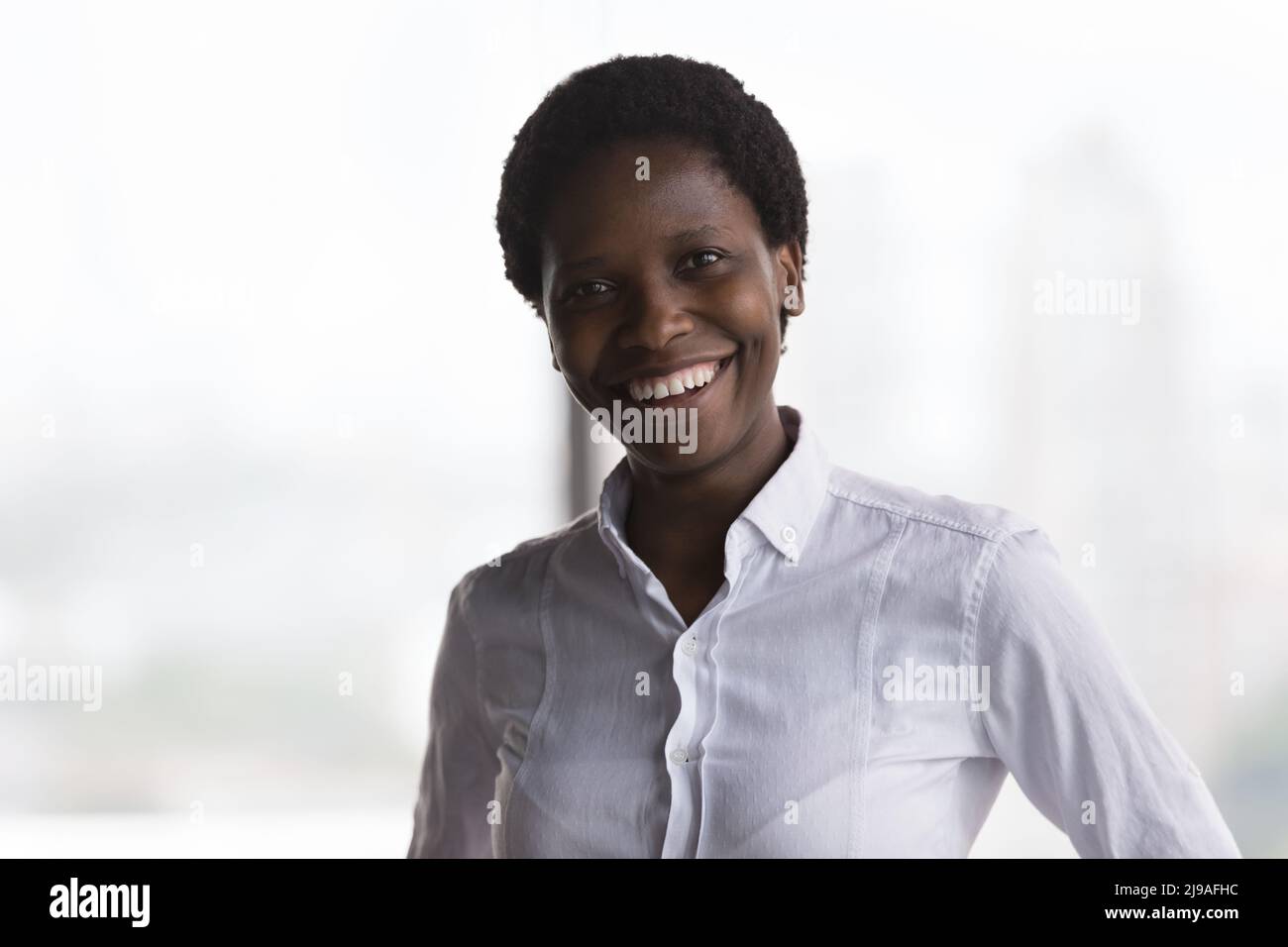 Headshot portrait smiling African businesswoman posing in office Stock ...