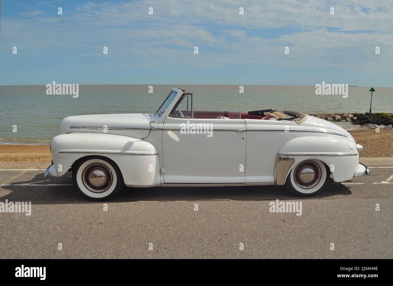 Classic White Ford Super Delux convertible  motorcar in show on seafront. Stock Photo