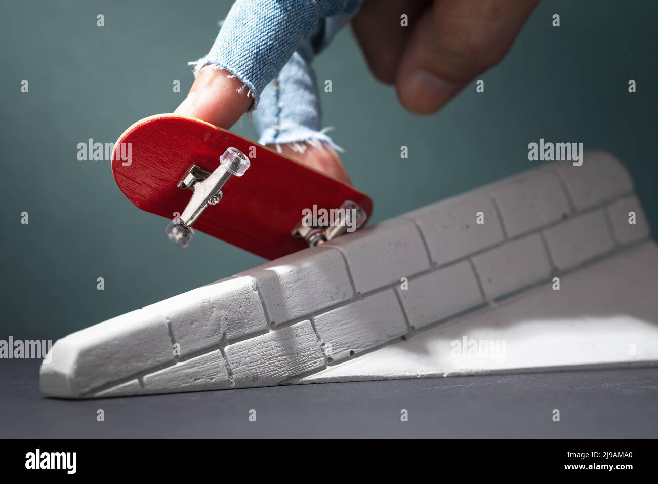 A man performs exercises with a fingerboard on a plaster ramp Stock