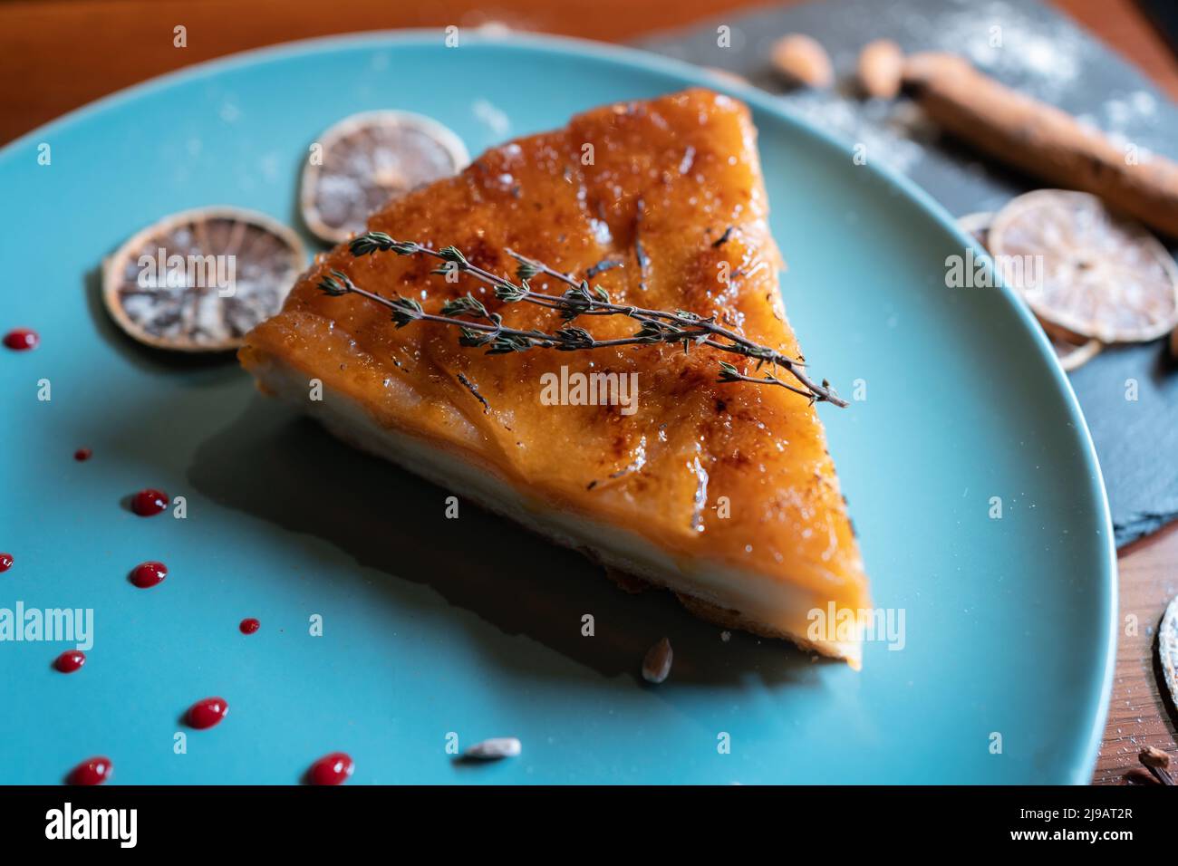 slicing fresh cheese or peer cake with mousse and cream and caramel crust Stock Photo
