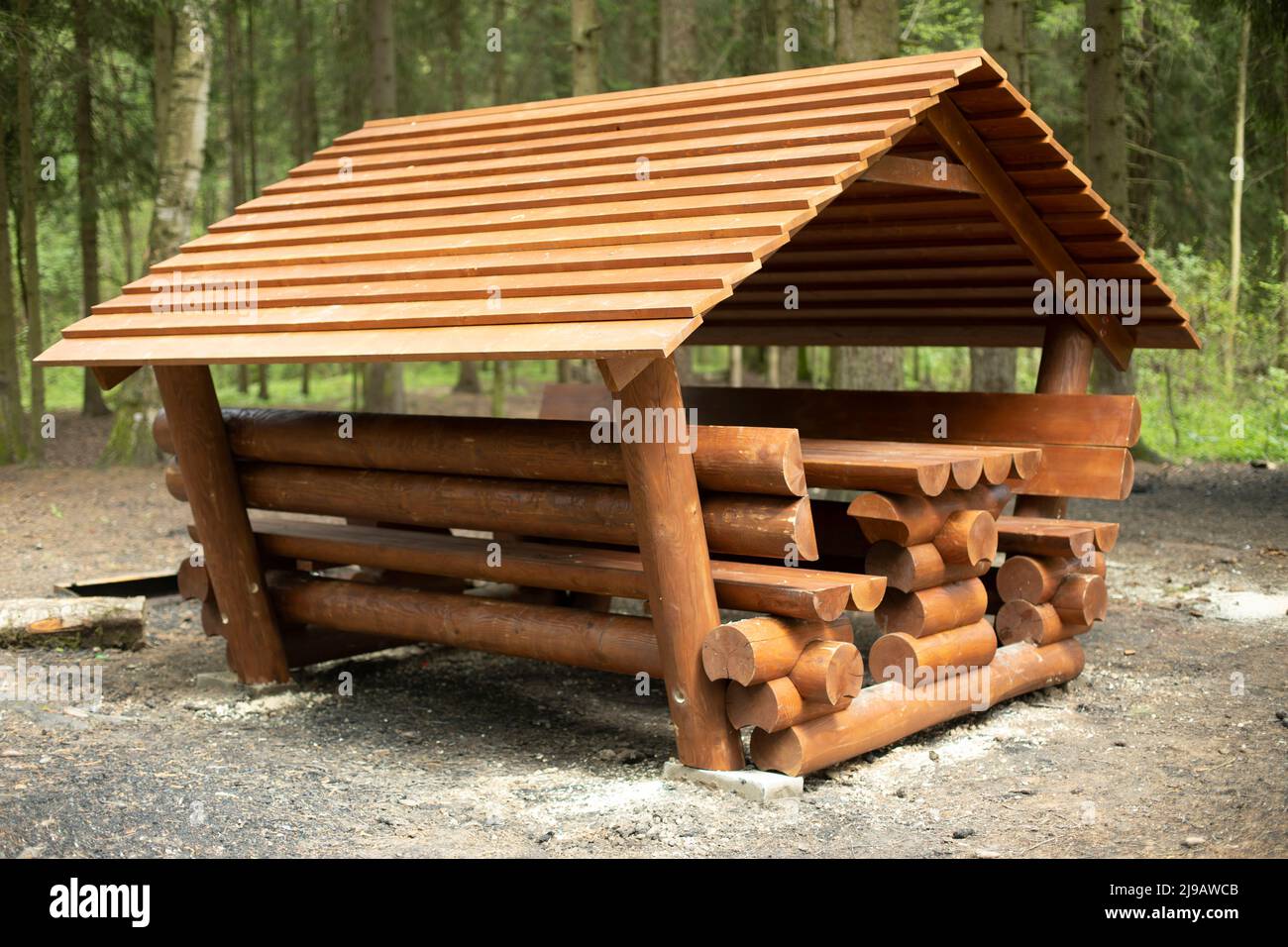Cabin for relaxation in forest. Place for picnic in nature. Log structure. Place to relax. Stock Photo