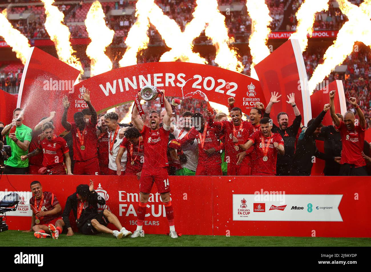 Jordan Henderson of Liverpool holds the FA Cup Trophy aloft as he and