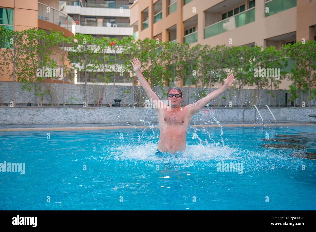 one swimmer jumps in a deep pool Stock Photo