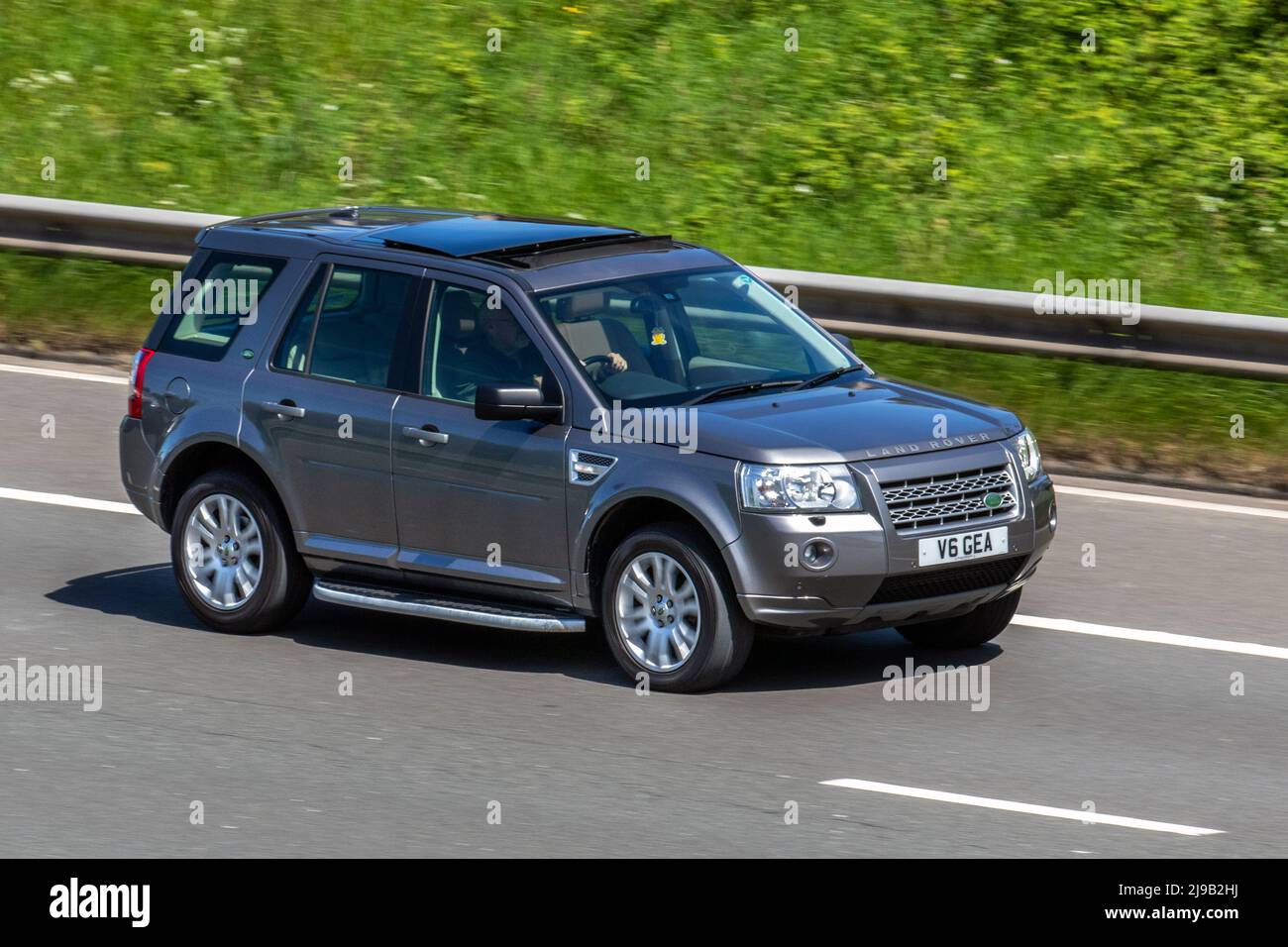 2010 grey LAND ROVER FREELANDER TD4 GS, compact crossover SUV 2179cc Diesel; driving on the M6 Motorway, Manchester, UK Stock Photo