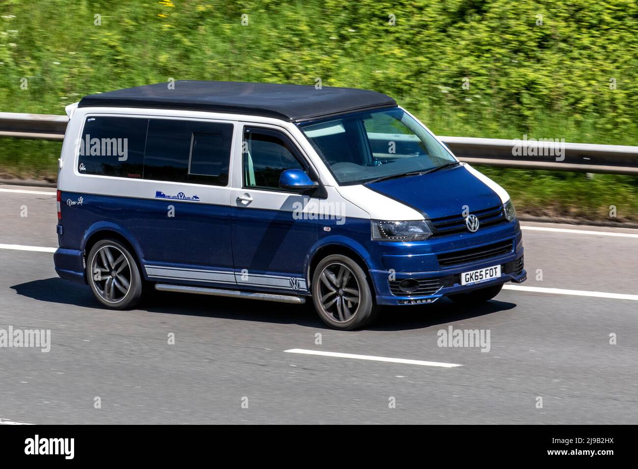 2015 white blue VW Volkswagen Transporter 1968 cc Diesel window van;  driving on the M6 Motorway, Manchester, UK Stock Photo - Alamy