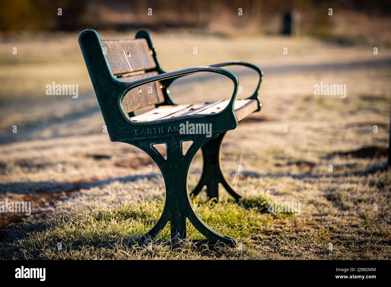 A bench in the park in the morning Stock Photo