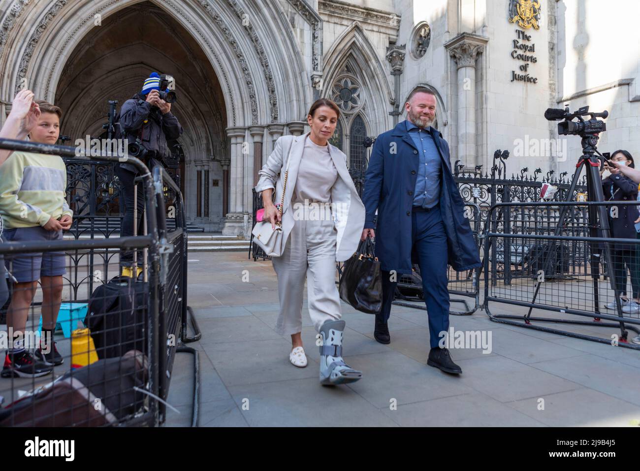 Coleen Rooney (L), accompanied by husband Wayne Rooney (R), leaves the Royal Courts of Justice after the fourth day of the ‘Wagatha Christie’ trial. Stock Photo
