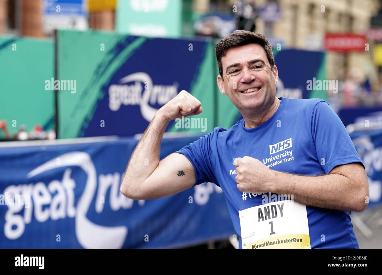 Mayor of Greater Manchester Andy Burnham shows his Manchester worker bee (symbol of Manchester) tattoo ahead of the Great Manchester Run through Manchester city centre, to mark the five-year anniversary of the Manchester Arena bombing. The day will be the first time in three years that people in Manchester can mark the anniversary free of coronavirus restrictions. Picture date: Sunday May 22, 2022. Stock Photo