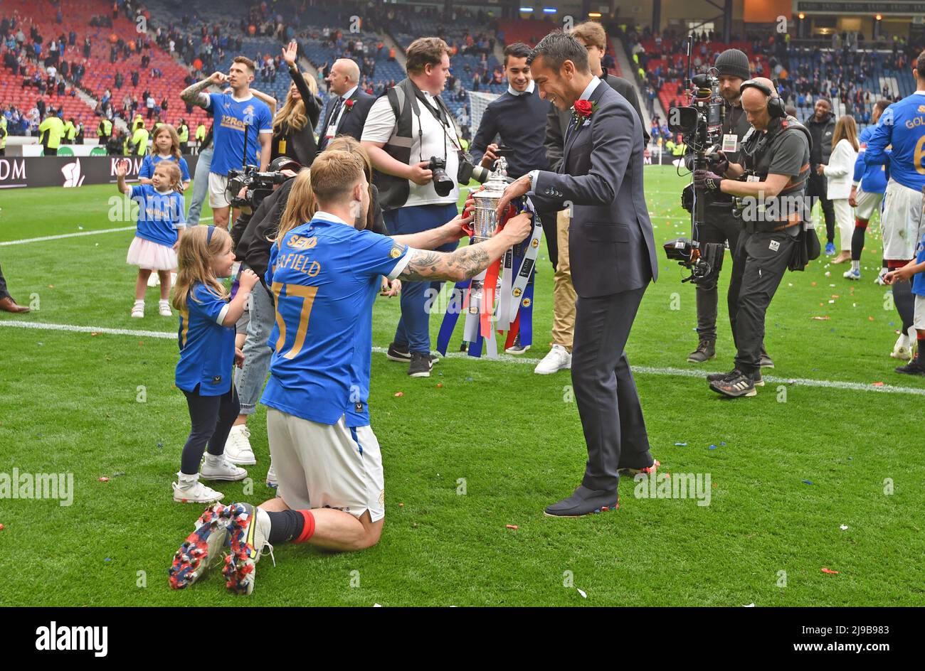 Glasgow, Scotland, 21st May 2022.   Scott Arfield of Rangers passes the Scottish Cup to Rangers Manager Giovanni van Bronckhorst after the Scottish Cup match at Hampden Park, Glasgow. Picture credit should read: Neil Hanna / Sportimage Stock Photo