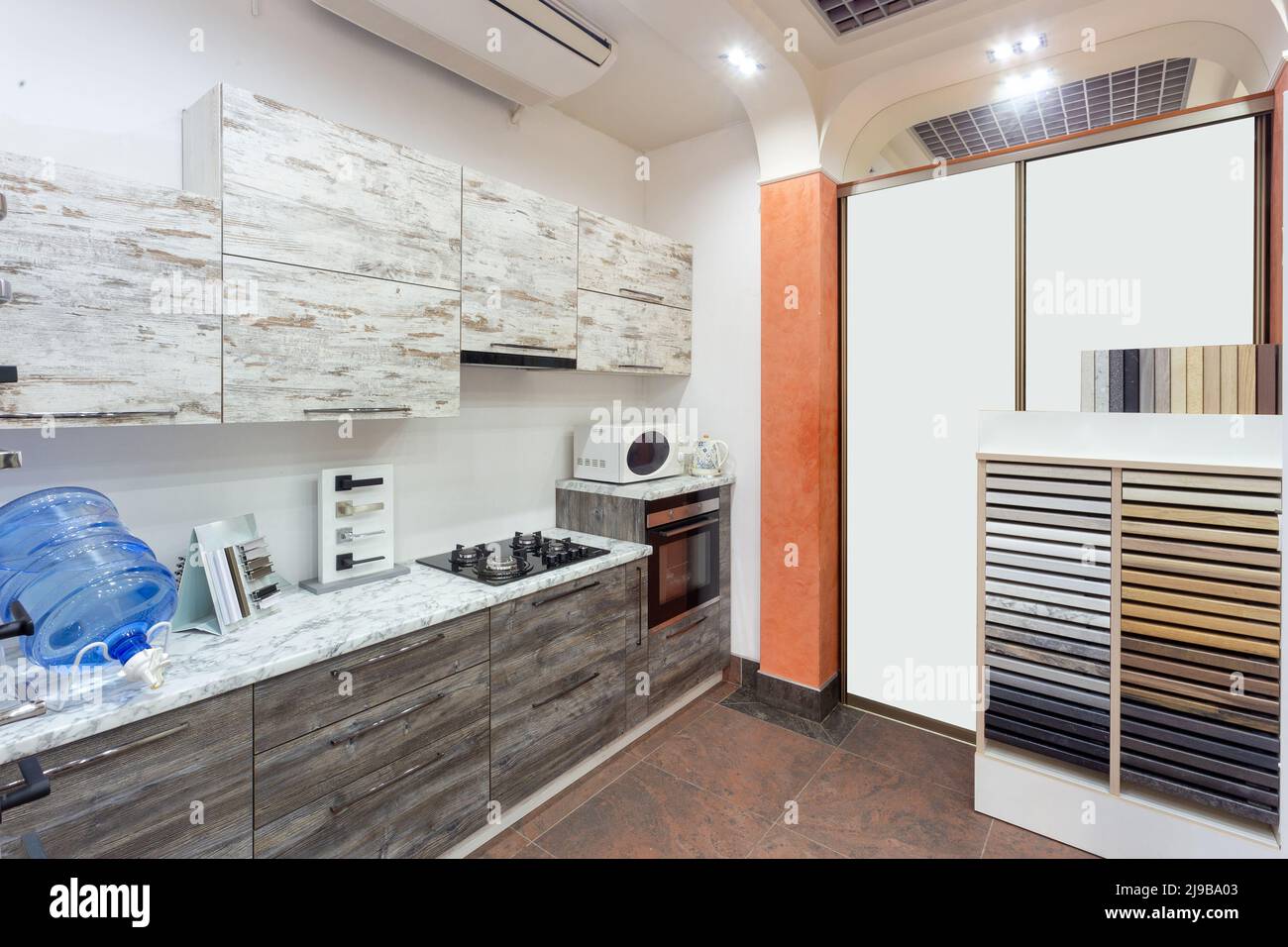 Kitchen interior designed in beige color and decorated in wood with